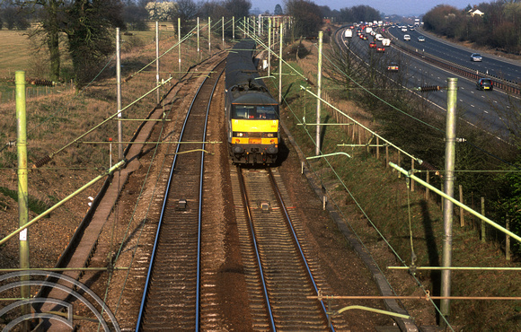 11975. 90050 heads South past traffic on the A12. Boreham. 18.3.03