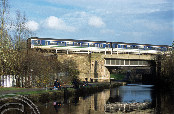 11548. FNW Class 156 passes over the Leeds and Liverpool canal. Wigan. 28.11.2002