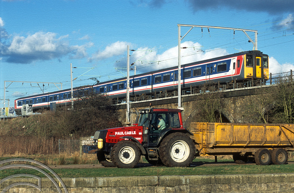 11874. 317348 speeds away from London. Walthamstow marshes. 6.03.2003.