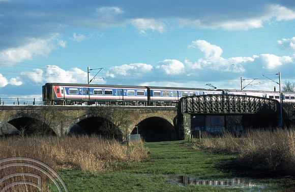 11872. 317348 speeds away from London. Walthamstow marshes. 6.03.2003.