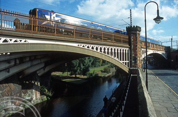 11122. FNW Class 158 crosses the Rochdale canal at Castlefield. Manchester. England. 9.10.02
