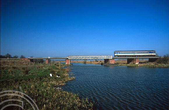 12007. Class 153 crosses the Great Ouse whilst working the 14.54 Ely - Ipswich. Ely. 22.03.03
