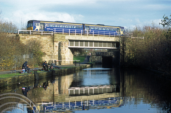 11550. FNW Class 142 passes over the Leeds and Liverpool canal. Wigan. 28.11.2002
