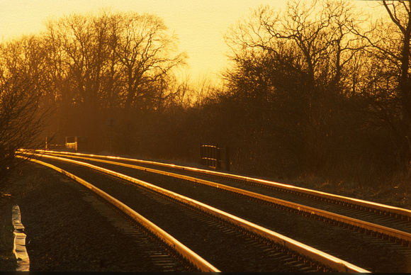 21034. Sunset along the tracks at Washstones level crossing. 13.2.01