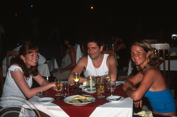 17284. Lynn and friends enjoying an evening meal.  Eriyadoo Island. Maldives. 16.1.2004. +