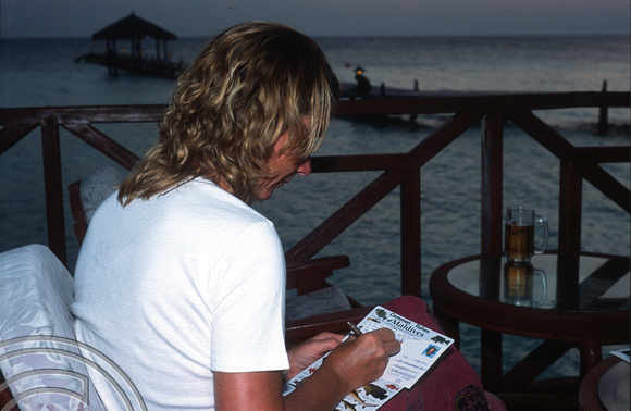 17321. Writing postcards. Eriyadoo Island. Maldives. 18.1.2004