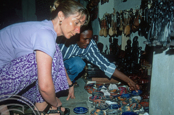 T10910. Lynn buying crafts. Stone Town. Zanzibar. Tanzania. Africa. 20th May 2001