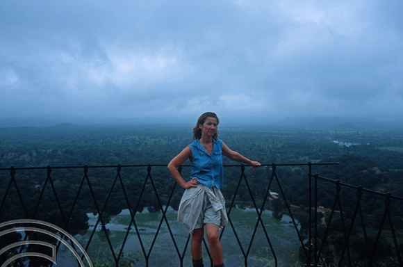 T14775. Lynn at the Summit of the palace ruins with Sigiri Wewa lake behind. Sigiriya. Sri Lanka. 3rd January 2003.