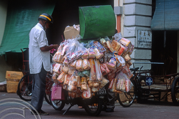 T04150. Selling bread from a scooter. Chinatown. Kuala Lumpur. Malaysia. 8th October 1992