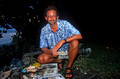 T9157. Me grilling parrot fish and Papaya. Rarotonga. Cook Islands. March 1999