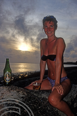 T9158. Lynn and a Cook's beer at Sunset. Piri Purito's. Rarotonga. Cook Islands. March 1999
