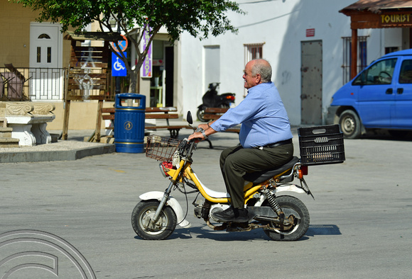 DG383009. Man on a scooter. Lardos. Rhodes. Greece. 18.10.2022.
