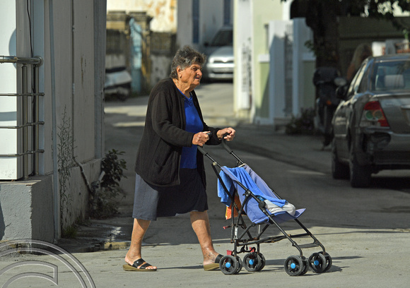 DG383191. Granny with shopping trolley pram. Lardos. Rhodes. Greece. 20.10.2022.