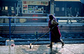 T09830. Washing the platform. Ahmedabad. Gujarat. India. Feb 2000.