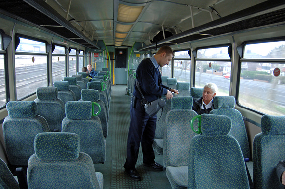 DG14618. Northern conductor checks tickets. 29.2.08.