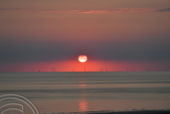 DG396915. Sunrise through wind turbines off North Wales coast. 16.6.2023.