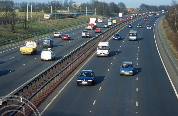 11980. A FGE service speeds past traffic on the A12. Boreham. 18.3.03