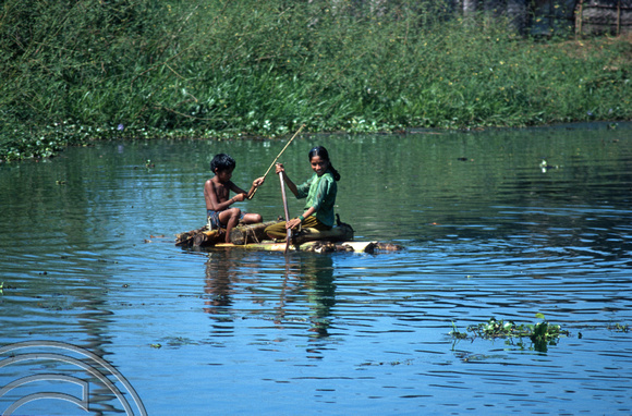 T6319. Children oon a home-made raft. Backwaters. Kerala. India. 29.12.1997