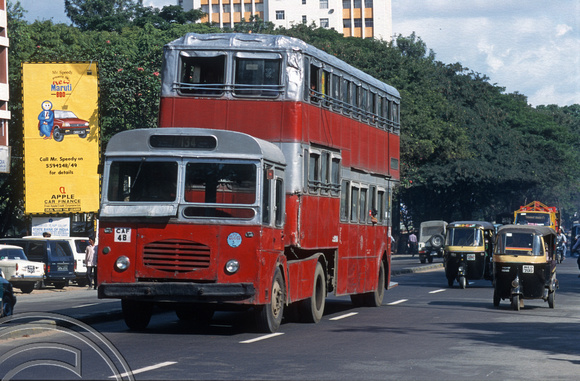 T6198. Double-deck articulated bus and traffic on MGR Rd. Bangalore. Karnataka. India. December.1997