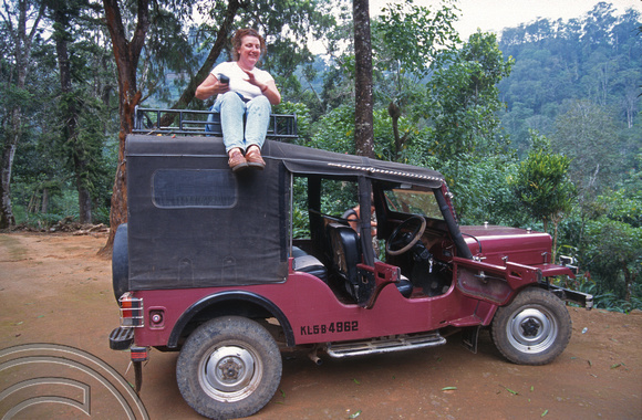 T6423. Alison atop a jeep. Periyar Wildlife sanctuary. Kerala. India. December.1997