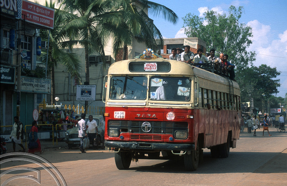 T6159. Local bus passes through the town. Hospet. Karnataka. India. December.1997