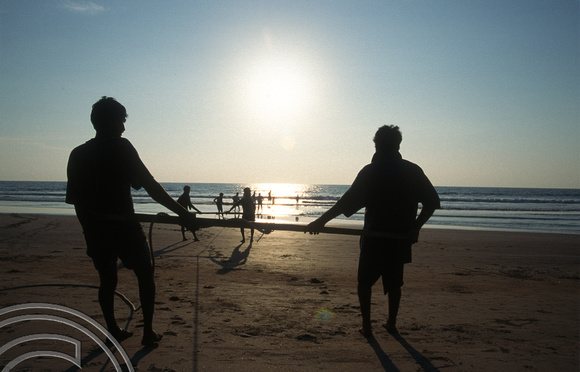 T6100. Fishermen pulling in their net on the beach. Arambol. Goa. India. December 1997