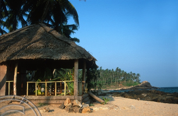 T14394. Looking East along the beach past a restaurant. Goyambokka. Tangalle. Sri Lanka. 26.12.02