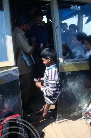 T6301. Boy begging on the local ferry to Ernakulam. Cochin. Kerala. India. December.1997
