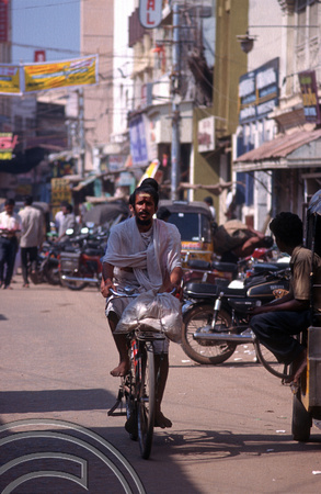 T6450. Pilgrim cycling to the temple. Madurai. India. January.1998
