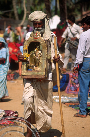T4483. Collecting alms at the Flea market. Anjuna. Goa. India. December 1993.