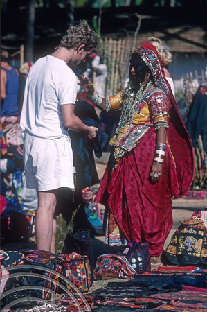 T4494. . Haggling with a tribal woman. Flea market. Anjuna. Goa. India. December 1993.