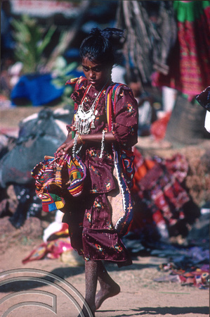 T4499 Girl selling bags. Flea market. Anjuna. Goa. India. December 1993.