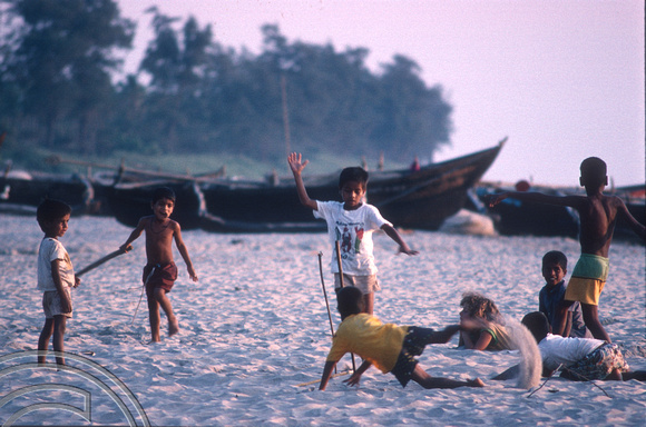 T4501. Kids playing cricket on the beach. Goa. India. December 1993.