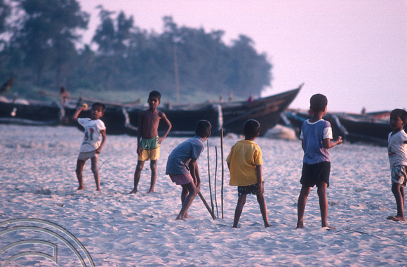 T4504. Kids playing cricket on the beach. Goa. India. December 1993.