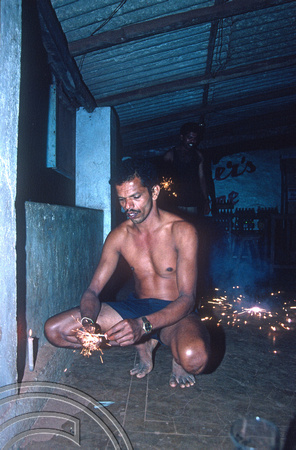 T4569. Umesh with fireworks. Arambol. Goa. India. 31st December 1993.