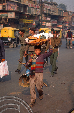 T4589. Boy carrying his stall. Paharganj. Old Delhi. India. January 1994.