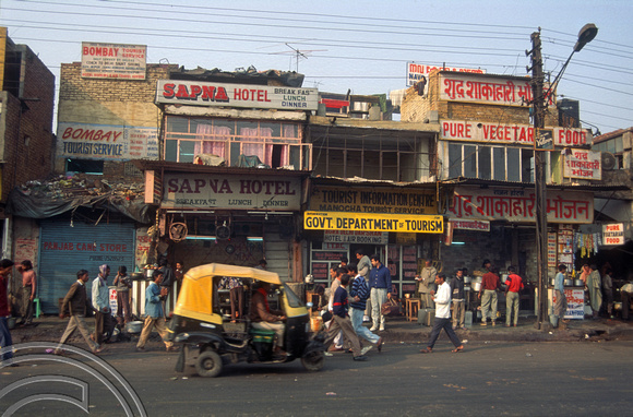 T4595. Collection of food emporiums opposite the station. Paharganj. Old Delhi. India. January 1994.