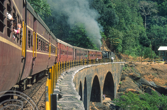 T03083. Vasco-Bangalore train banked by a steam engine 30154. Dudhsagar. Goa. India. December 1991.