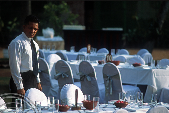 17225. Waiter checking tables for a weeding at the Galle Face Hotel. Colombo. Sri Lanka. 10.01.04