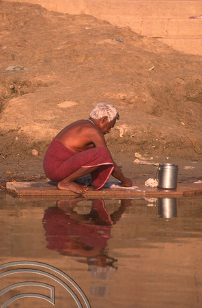 T6819. Man washing his clothes in the Ganges. Varanasi. Uttar Pradesh. India. Frebruary 1998