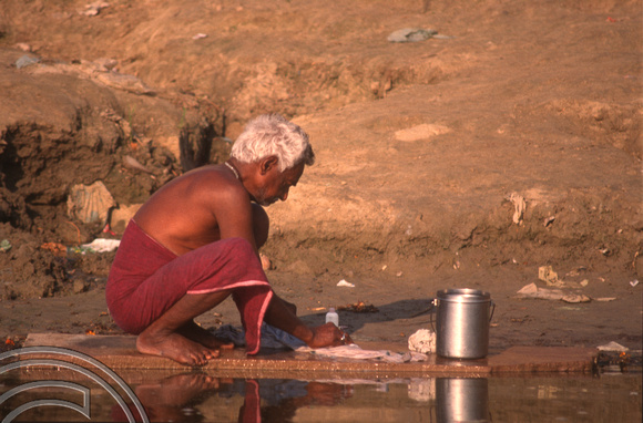 T6818. Man washing his clothes in the Ganges. Varanasi. Uttar Pradesh. India. Frebruary 1998