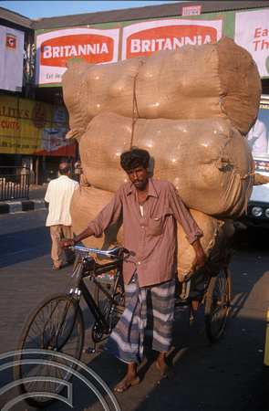T6684. Cycle rickshaw. Driver and load. Chennai. Tamil Nadu. India. February 1998