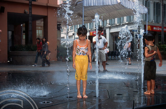 T015712. Children playing in a fountain. Bugis Junction. Singapore. 7th September 2003