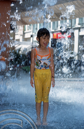 T015713. Child playing in a fountain. Bugis Junction. Singapore. 7th September 2003