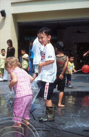 T015715. Children playing in a fountain. Bugis Junction. Singapore. 7th September 2003