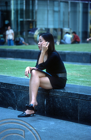 T015811. Modern girl . Raffles Place. Singapore. 8th September 2003