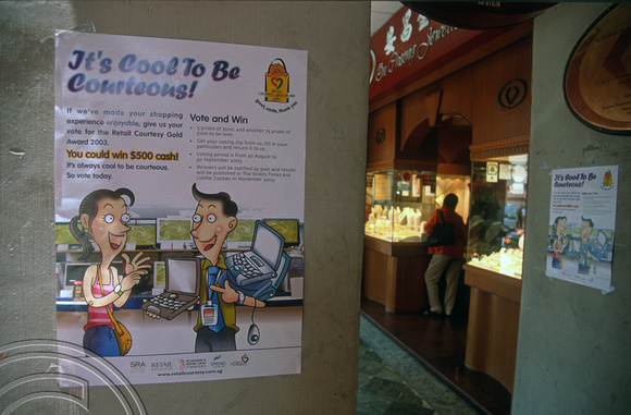 T015791. Poster encouraging shop owners to be courteous. South Bridge Rd. Singapore. 8th September 2003