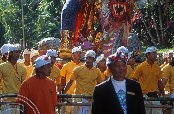 T015882. Carrying the Statue of a God in a procession. Ubud. Bali. Indonesia. 19th September 2003