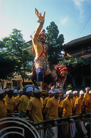 T015894. Men carry a statue of a god in a procession. Ubud. Bali. Indonesia. 19th September 2003