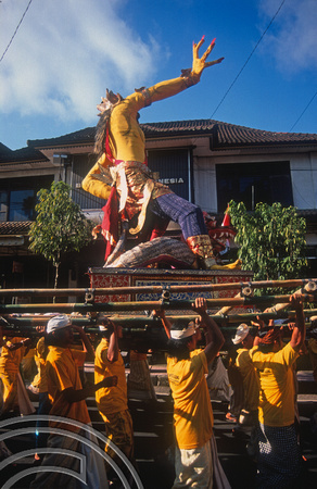 T015899. Men carry a statue of a god in a procession. Ubud. Bali. Indonesia. 19th September 2003